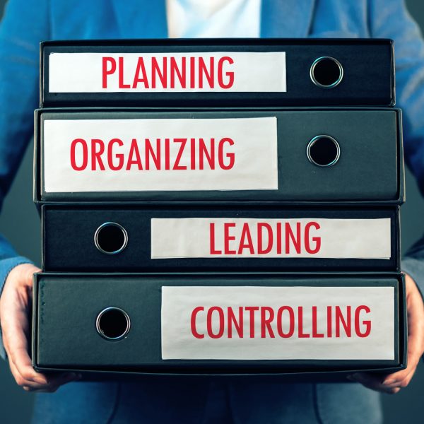 Four basic functions of management process in business organization - planning, organizing, leading and controlling.