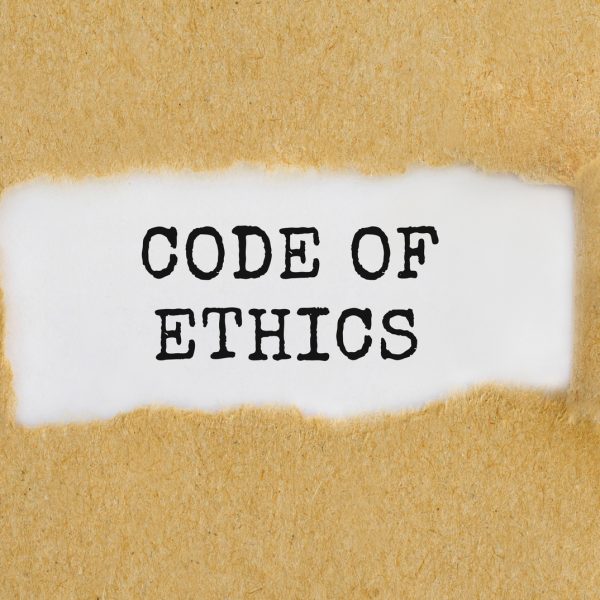 Text Code Of Ethics appearing behind ripped brown paper.
