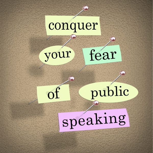 Conquer your fear of public speaking words on papers pinned to a bulletin board, advice to overcome stage fright when giving a major speech at an event or meeting