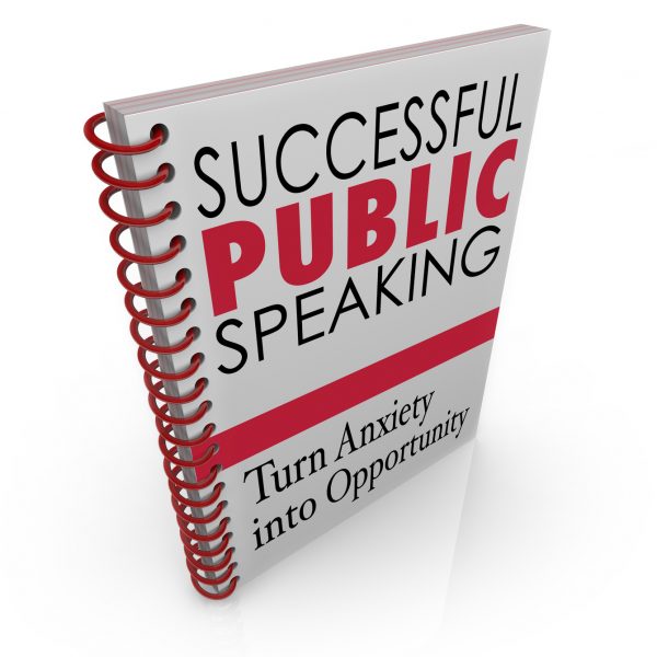 Successful Public Speaking words on a book cover for advice, help, tips and assistance in delivering a big speech at an event, meeting or conference